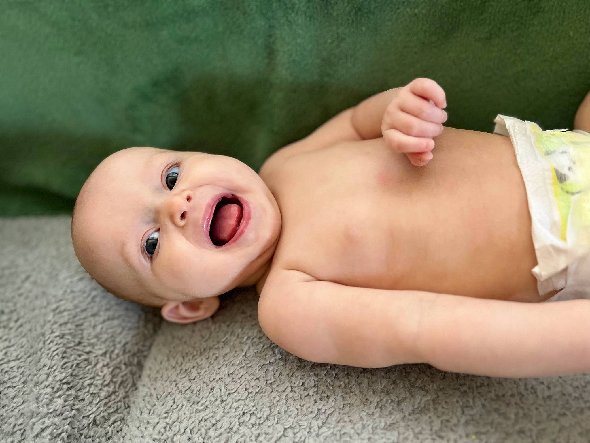 Arden is registered to the contest to win money with this photo: baby, baby_toddler_clothing, cheek, chest, child, close_up, comfort, eyelash, finger, flash_photography, foot, grass, happy, human_body, human_leg, person, skin, smile, stomach, toddler