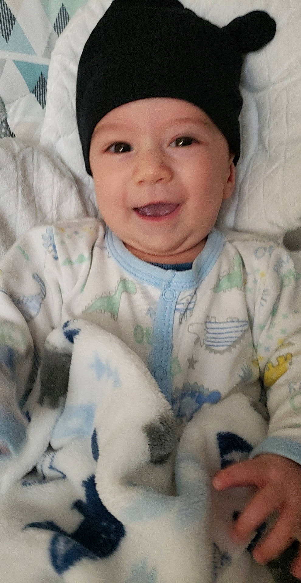 Leroy is registered to the contest to win money with this photo: baby, baby_toddler_clothing, cap, cheek, child, comfort, dress, eye, face, finger, gesture, hand, happy, head, headgear, headwear, joy, nose, person, skin