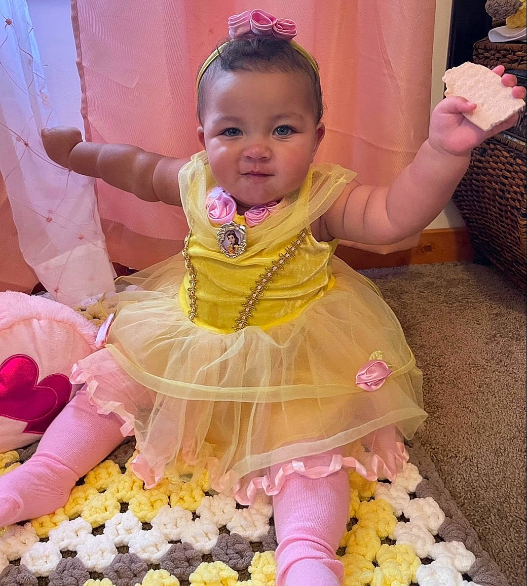 Wynter is registered to the contest to win money with this photo: baby, baby_products, baby_toddler_clothing, beauty, cheek, child, costume, event, fun, happy, magenta, peach, person, pink, play, ruffle, sitting, skin, smile, textile