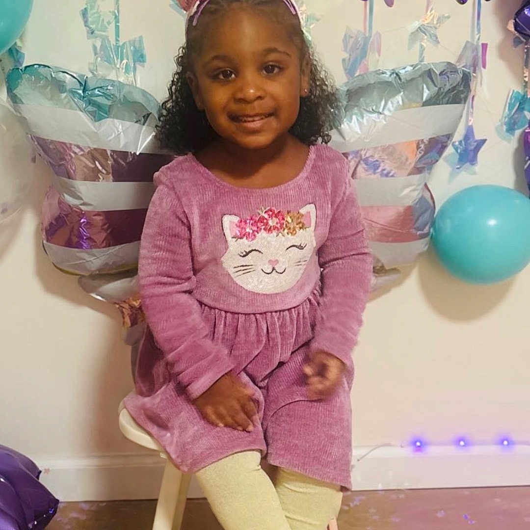 Xianah is registered to the contest to win money with this photo: balloons, butterfly_decorations, celebration, chair, child, curly_hair, cute, festive, floor, girl, happy, indoor, party, portrait, purple_dress, sitting, smiling, tights, unicorn_headband, wall_decor