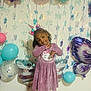 Xianah is registered to the contest to win money with this photo: child, girl, birthday, balloons, unicorn_headband, pink_dress, smile, curly_hair, party, celebration, decorations, stars, wall, indoor, happy, posing, festive, cute, colorful, headwear