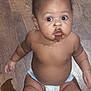 baby, child, diaper, chocolate, messy, floor, wooden_floor, sitting, curious, wide_eyes, face, mouth, skin, indoor, infant, cute, young_child, expression, portrait, person