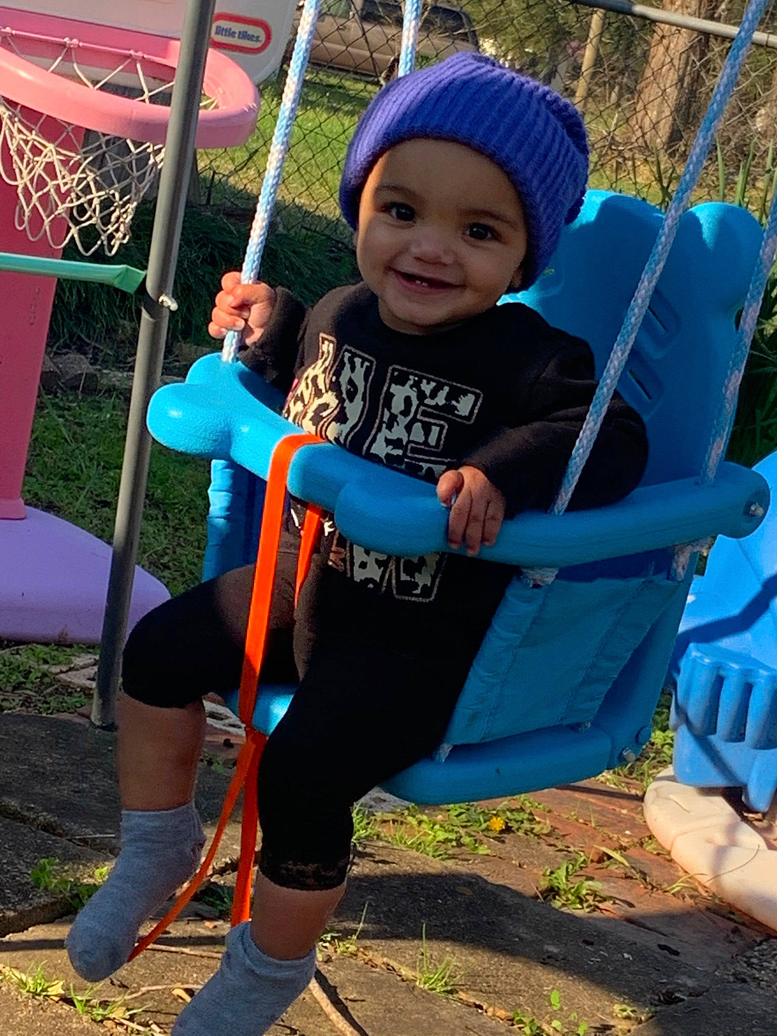 Caylin joined the competition — help win amazing prizes! child, electric_blue, headwear, joy, outdoor_play_equipment, person, play, playground, public_space, smile, swing, toddler, tree