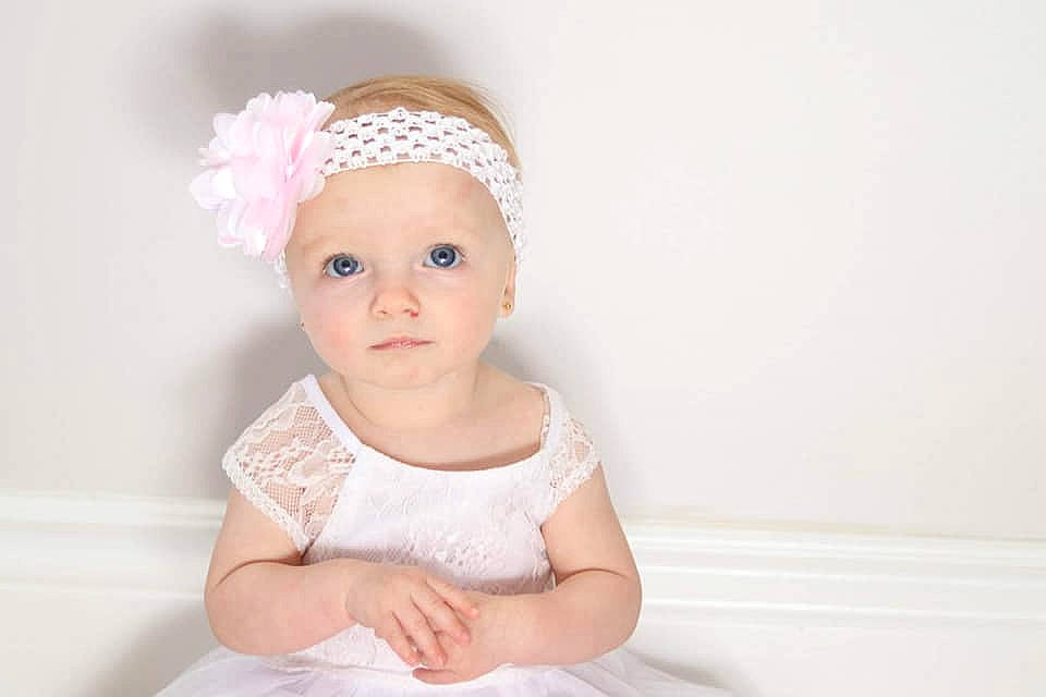Layla-rose is registered to the contest to win money with this photo: baby, baby_toddler_clothing, bridal_accessory, cheek, child, dress, face, fashion_accessory, hair_accessory, head, headband, headgear, headpiece, person, photograph, photography, pink, portrait_photography, skin, toddler