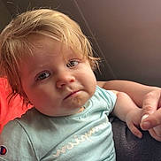Nora'Rai joined the competition — help win amazing prizes! toddler, child, face, person, hand, light_blue_shirt, indoor, curly_hair, messy_hair, expression, skin, portrait, sitting, holding_hand, casual_clothing, young_child, cute, baby, closeup, soft_lighting