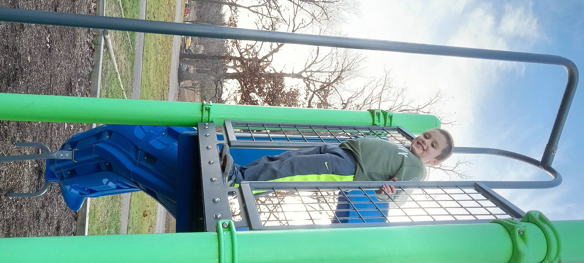 Mason is registered to the contest to win money with this photo: automotive_exterior, bumper, cloud, electric_blue, fun, gas, grass, joy, leisure, machine, mesh, motor_vehicle, outdoor_play_equipment, person, pipe, recreation, roof, sky, tire, tree