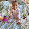 Kimiya joined the competition — help win amazing prizes! baby, child, infant, smiling, sitting, toy, bedspread, patterned, indoors, cute, pink, clip, happy, face, person, play, colorful, room, soft, cozy