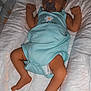 baby, sleeping, pacifier, blue_onesie, blanket, pillow, glowing_ball, infant, child, cute, cozy, bedtime, resting, soft, indoor, peaceful, newborn, lying_down, comfort, toddler