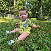 Beck is registered to the contest to win money with this photo: baby, bench, casual, child, expression, fence, grass, greenery, nature, outdoor, park, pineapple_pattern, playful, socks, summer, sunlight, toddler, tongue_out, trees, yellow_clothing