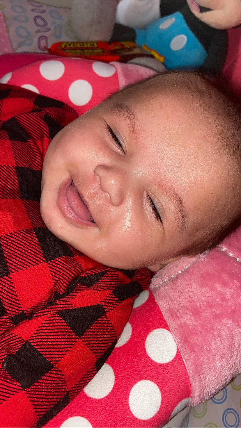 Maelani is registered to the contest to win money with this photo: cheek, chin, collar, eye, eyebrow, eyelash, happy, iris, joy, lip, mouth, nose, person, pink, plaid, red, skin, sleeve, smile, tartan