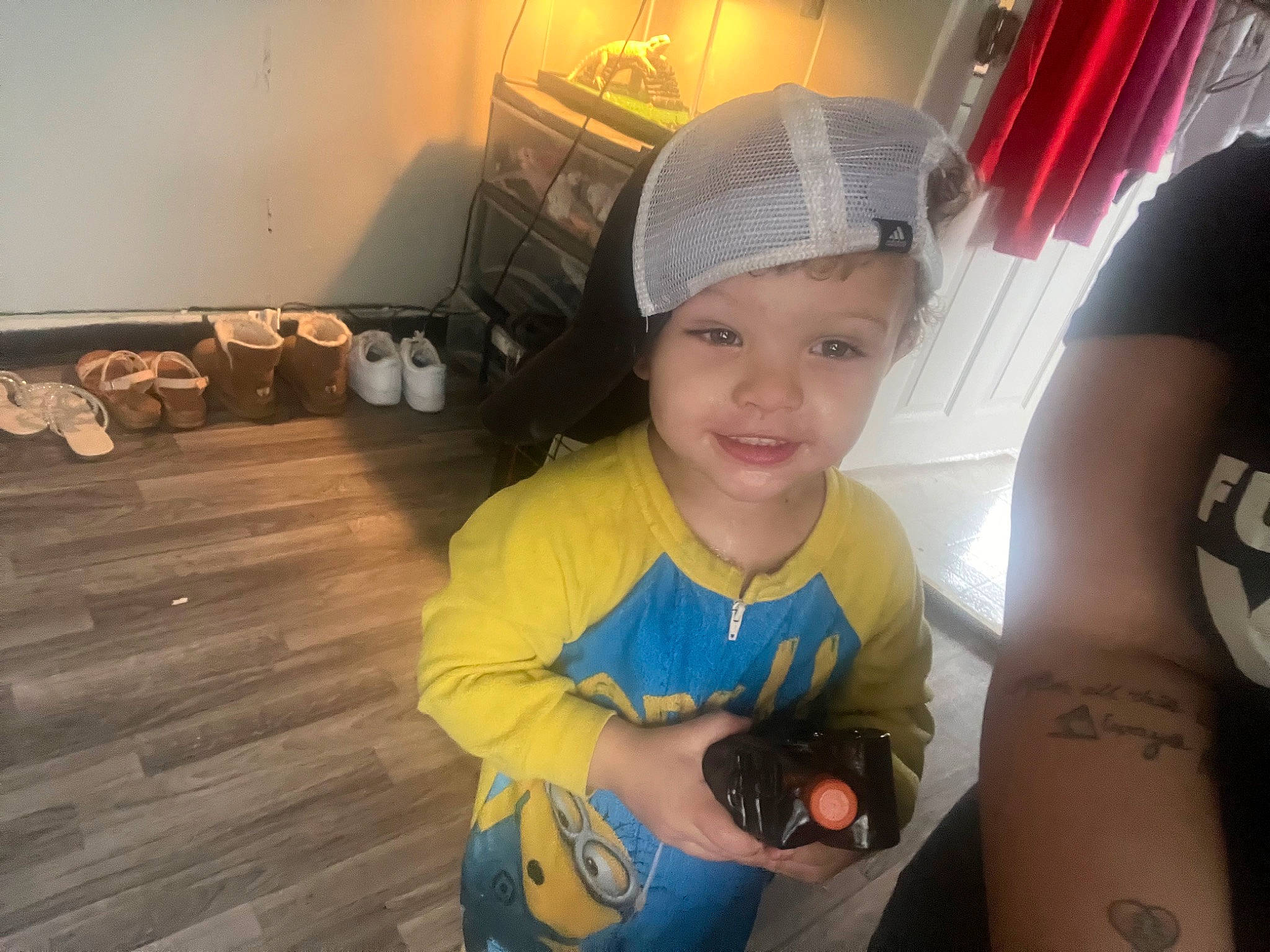 Malakai is registered to the contest to win money with this photo: automotive_lighting, baseball_cap, cap, child, cool, elbow, eye, finger, fun, hand, happy, headwear, human_body, joy, person, skin, smile, t_shirt, temporary_tattoo, thumb