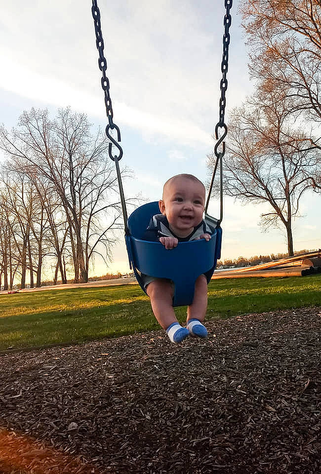 Roman joined the competition — help win amazing prizes! child, city, fun, grass, human_settlement, outdoor_play_equipment, person, plant, play, playground, public_space, recreation, sky, smile, spring, swing, toddler, tree