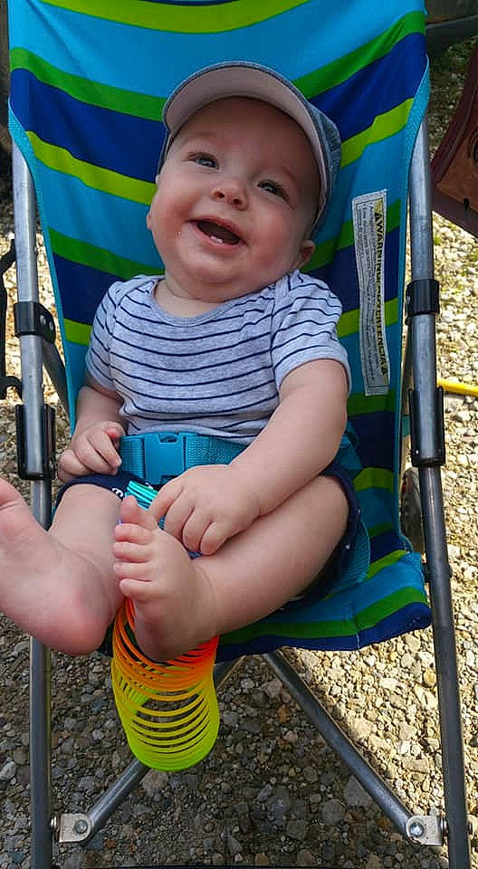 Roman is registered to the contest to win money with this photo: baby, child, person, play, playground, product, public_space, sitting, smile, toddler, vacation