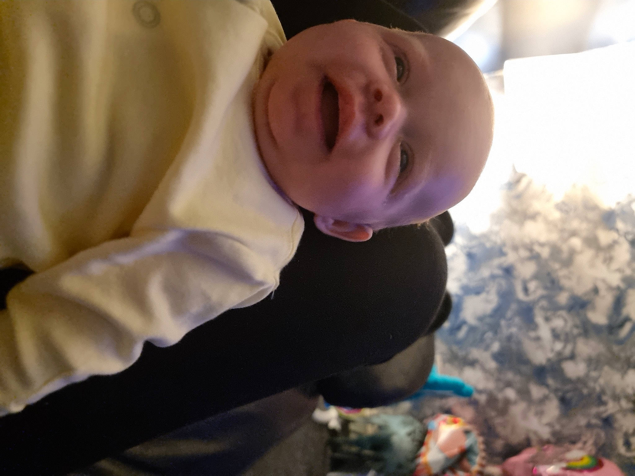 Esmae is registered to the contest to win money with this photo: baby, baby_products, baby_toddler_clothing, child, fun, grass, happy, hoodie, laugh, person, room, sitting, sleeve, smile, soil, toddler, tree