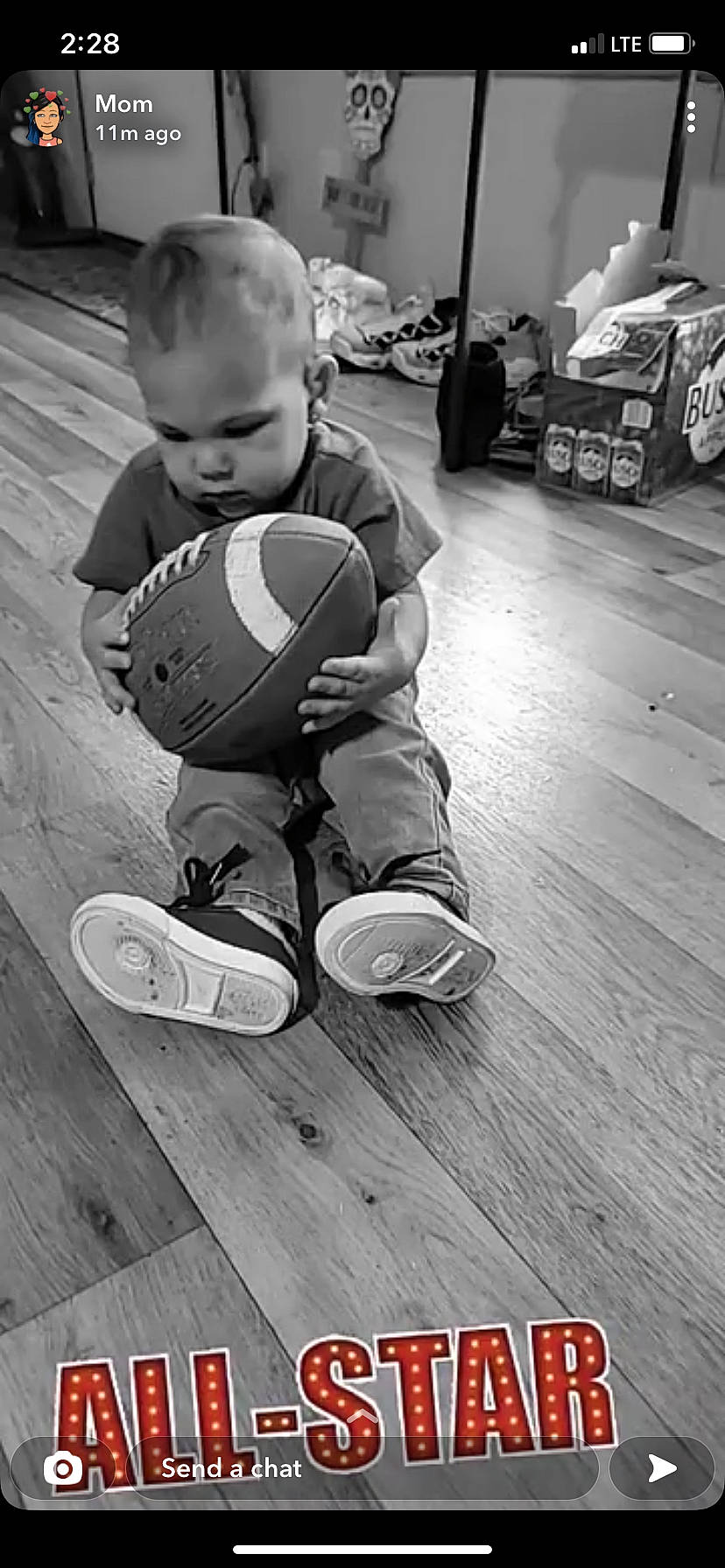 Bakari is registered to the contest to win money with this photo: arm, ball, black, black_and_white, floor, flooring, football, hand, human_body, jeans, leg, person, photograph, shoe, sneakers, sports_equipment, sports_gear, standing, style, white