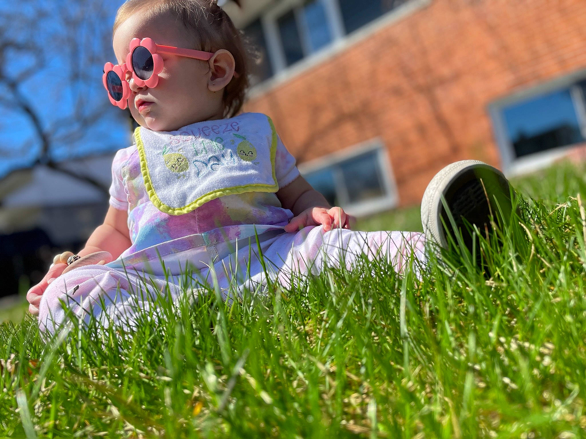 Laina is registered to the contest to win money with this photo: baby, baby_toddler_clothing, child, eyewear, fun, goggles, grass, grassland, happy, head, lawn, leisure, meadow, people_in_nature, person, plant, recreation, sitting, sunglasses, sunlight