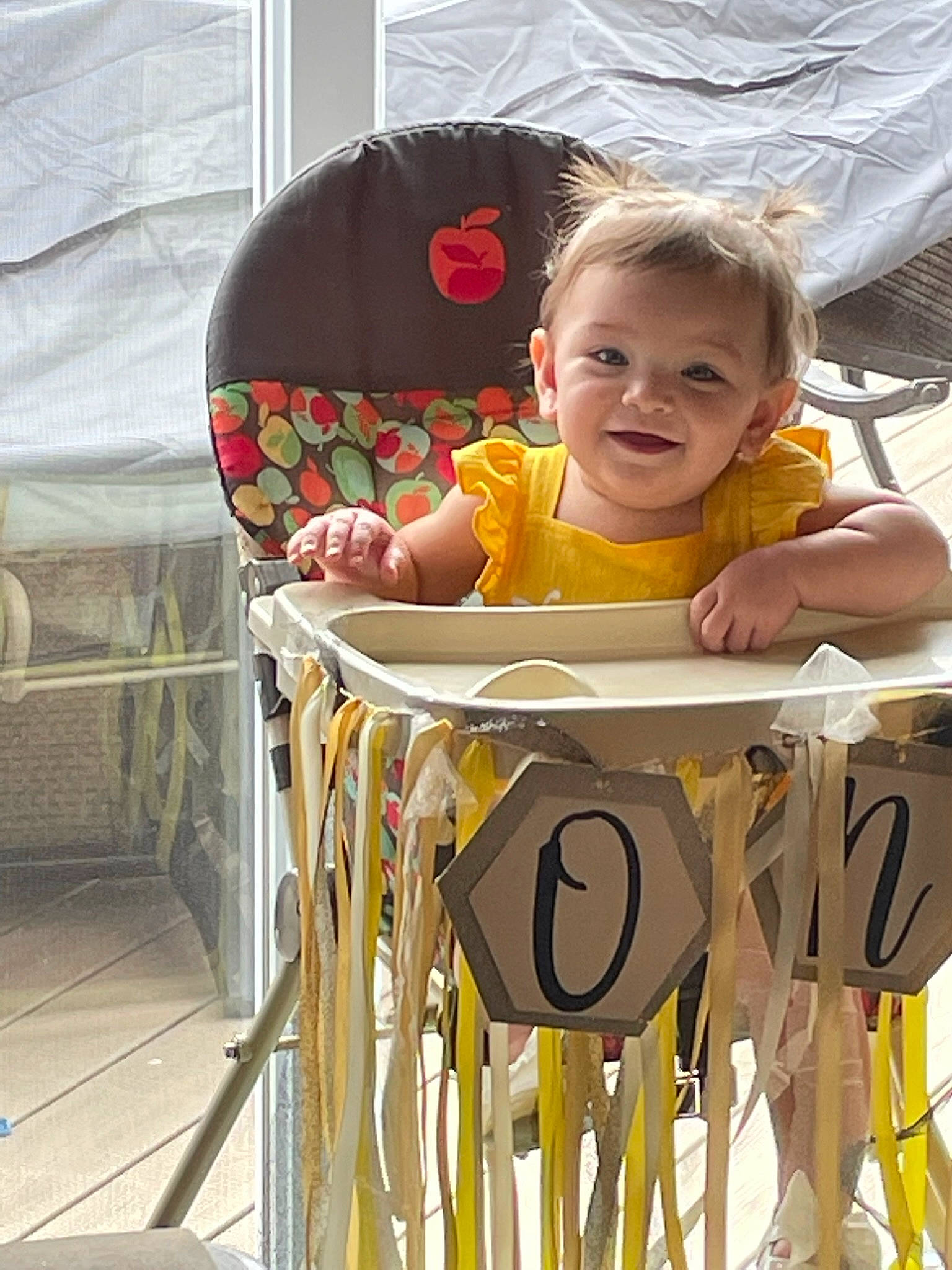 Laina is registered to the contest to win money with this photo: baby, baby_products, baby_safety, baby_toddler_clothing, chair, child, comfort, facial_expression, fun, happy, joy, leisure, pattern, person, play, room, sitting, sleeve, smile, t_shirt