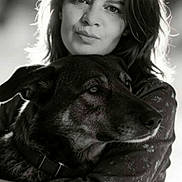 Dimi participe au concours pour gagner de l'argent avec cette photo : affectionate, black_and_white, bokeh, calm, close_up, collar, companion, dog, eyes, face, fur, hair, hug, natural_light, outdoor, pet, photography, portrait, sleeve, woman