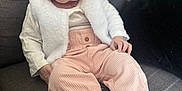 Mia a rejoint le concours — aidez-le/la à gagner de superbes lots ! baby, bodypart, clothing, coat, couch, dress, face, finger, furniture, hand, happy, head, longsleeve, pants, person, photography, portrait, sitting, sleeve, smile