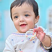Ayzal Chaudhry is registered to the contest to win money with this photo: toddler, child, smiling, face, hand, jewelry, bracelet, beads, clothing, embroidered, hair_clip, cute, portrait, happy, person, baby, fashion, colorful, background, outdoor
