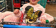 Aitana joined the competition — help win amazing prizes! toddler, child, shopping_cart, pink_clothing, hat, smiling, indoor, store, aisle, water_bottle, price_sign, toy, happy, cute, clothing, person, retail, baby, warm, fun