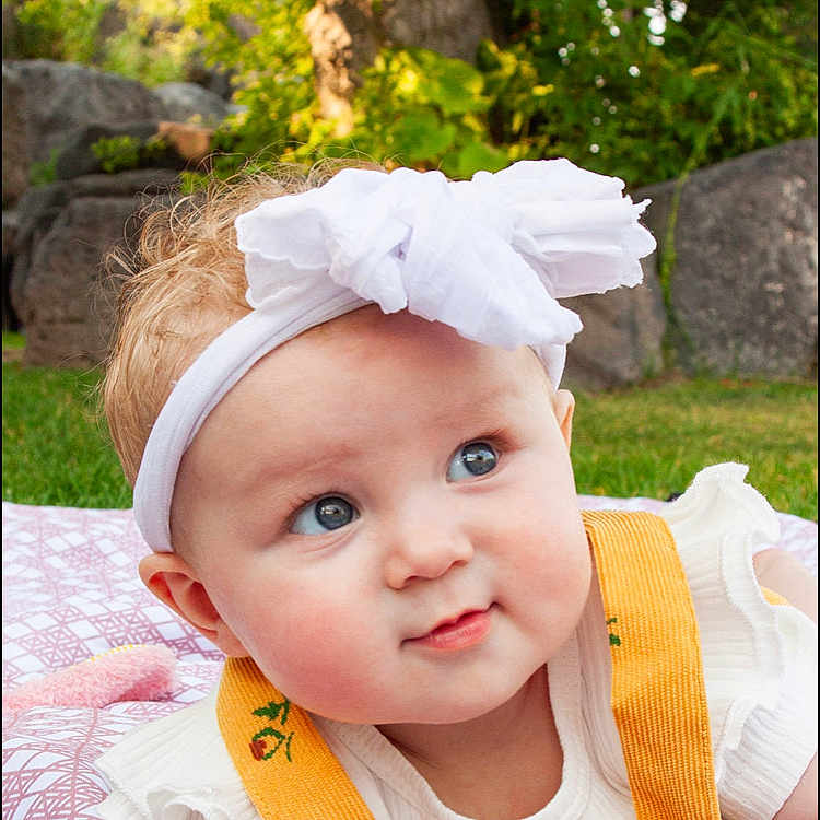 Saige is registered to the contest to win money with this photo: accessories, baby, clothing, costume, dress, face, grass, happy, head, headband, homedecor, linen, person, photography, plant, portrait, quilt, smile, tree, vegetation