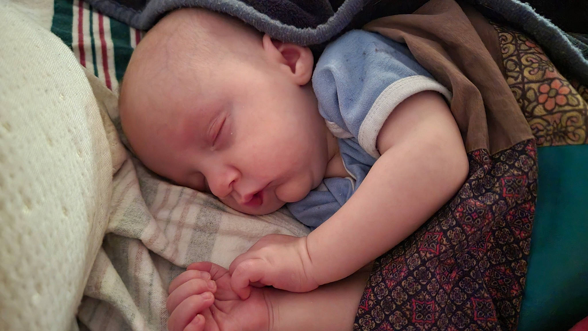 Dean is registered to the contest to win money with this photo: baby, baby_products, baby_sleeping, baby_toddler_clothing, bedtime, cheek, child, comfort, finger, gesture, grass, linens, nap, pattern, person, portrait_photography, room, skin, sleep, thumb