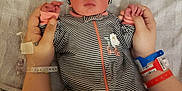 Adalynn is registered to the contest to win money with this photo: accessories, arm, baby, bodypart, bonnet, bracelet, cap, clothing, couch, face, finger, furniture, glove, hand, hat, head, jewelry, newborn, person, wrist