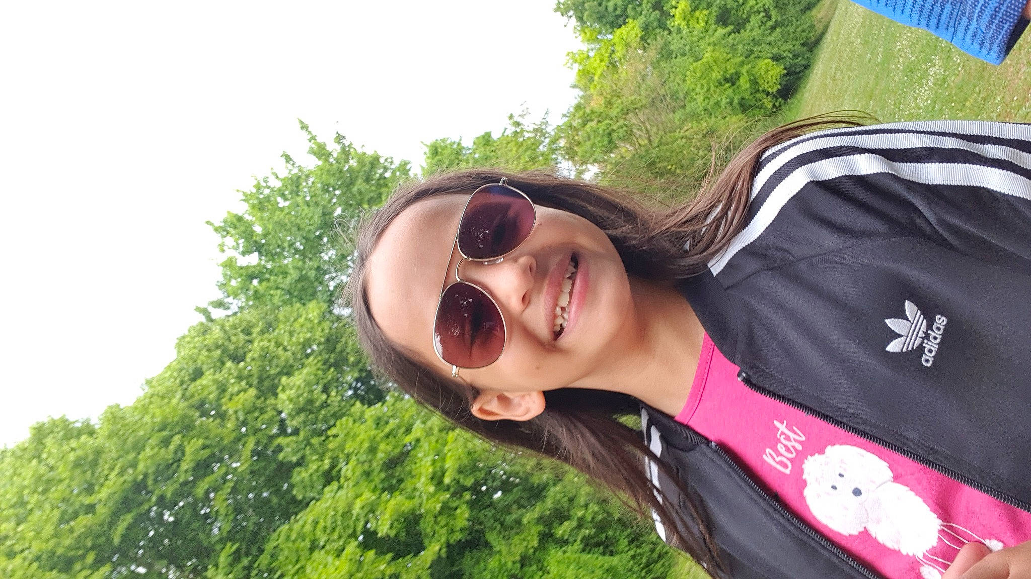 Kelly a rejoint le concours — aidez-le/la à gagner de superbes lots ! eyewear, fashion_accessory, fun, glasses, goggles, grass, happy, jewellery, joy, leisure, necklace, people_in_nature, person, plant, recreation, sky, sleeve, smile, sunglasses, travel