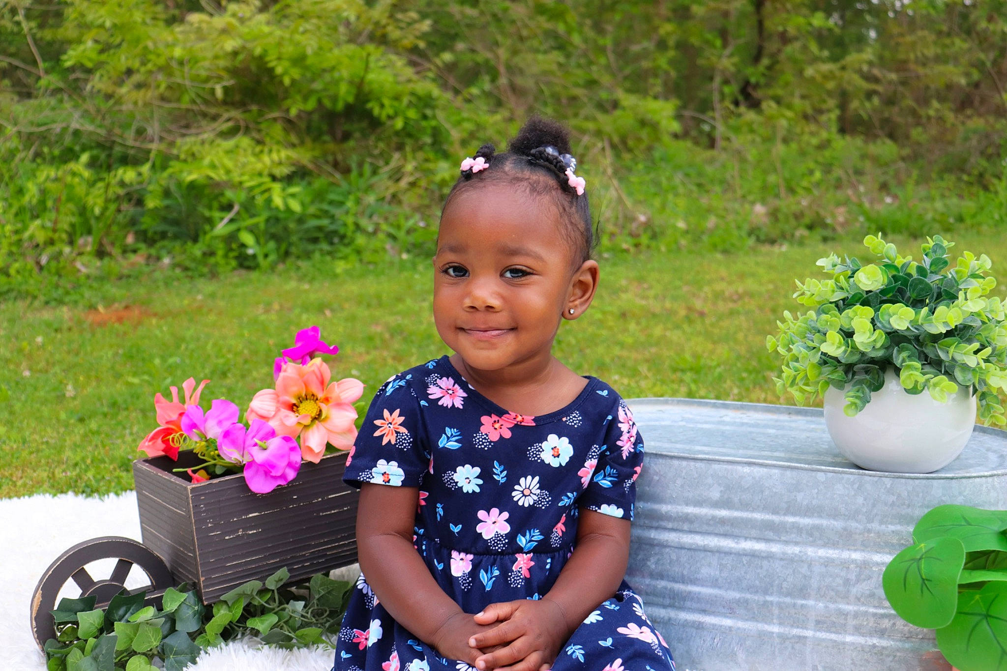 Paityn is registered to the contest to win money with this photo: annual_plant, baby_toddler_clothing, child, event, flower, flowerpot, garden, grass, green, happy, houseplant, joy, leisure, people_in_nature, person, petal, plant, shrub, smile, tire