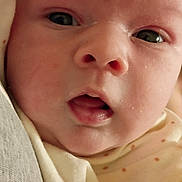 Morgan is registered to the contest to win money with this photo: baby, blanket, child, closeup, clothing, cute, expression, eyes, face, human, indoors, infant, mouth, newborn, person, polka_dot, portrait, skin, soft, wearing