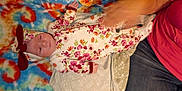 Morgan is registered to the contest to win money with this photo: arm, baby, blanket, casual, colorful, comfort, cute, fabric, floral_clothing, hand, headband, indoor, infant, newborn, pattern, person, resting, sleeping, soft, tie_dye