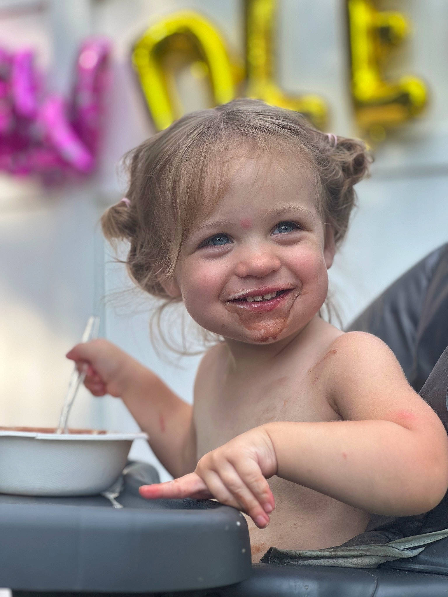 Brynn is registered to the contest to win money with this photo: baby, bathing, blond, cheek, chest, child, event, facial_expression, finger, fun, gesture, hairstyle, hand, happy, joy, laugh, leisure, person, recreation, sitting