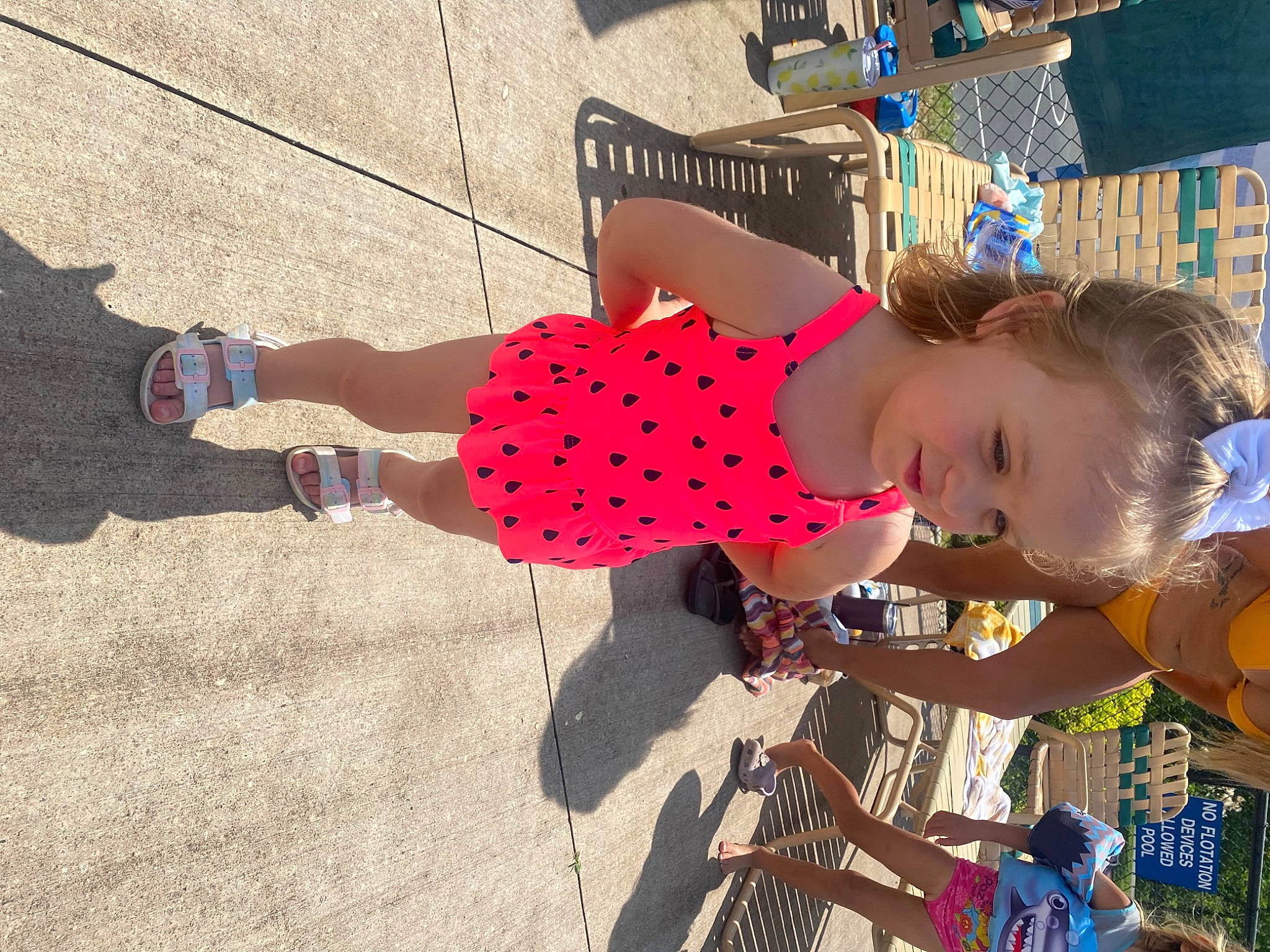 Brynn is registered to the contest to win money with this photo: carmine, child, city, flooring, fun, happy, human_leg, leisure, pattern, person, play, recreation, road_surface, sitting, toddler, toy, tree