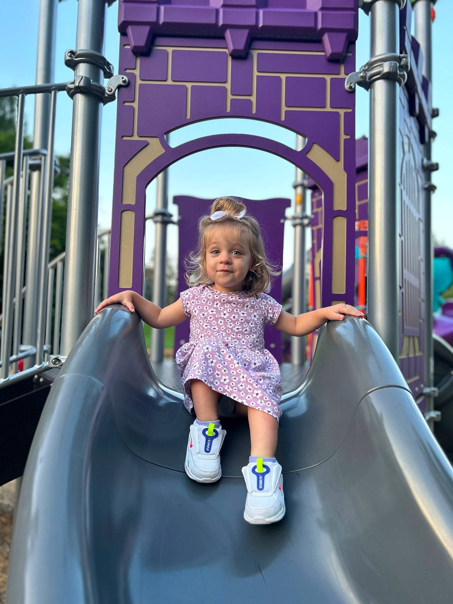 Brynn joined the competition — help win amazing prizes! baby_toddler_clothing, child, chute, city, fun, happy, leisure, magenta, outdoor_play_equipment, person, pink, play, playground, playground_slide, purple, recreation, sky, standing, t_shirt, toddler