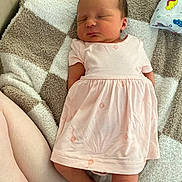 Lyla joined the competition — help win amazing prizes! newborn, baby, sleeping, infant, pink_dress, dress, blanket, cozy, portrait, indoors, lying_down, peaceful, closed_eyes, face, feet, legs, textile, cushion, home, photography