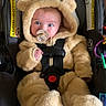 Lyla is registered to the contest to win money with this photo: baby, infant, child, car_seat, teddy_bear_costume, hood, fluffy, pacifier, blue_eyes, wide_eyed, sitting, buckled, harness, portrait, indoor, automobile, safety_seat, plush, cute, photography
