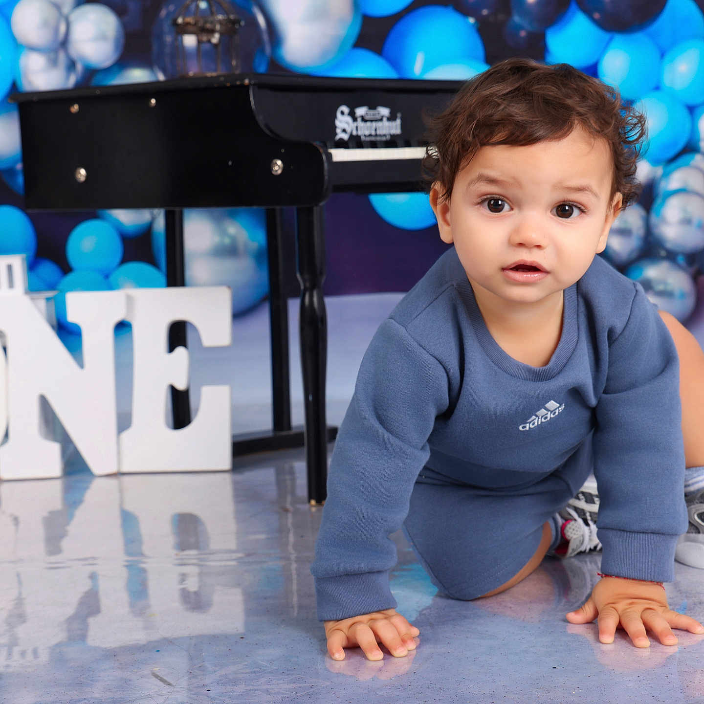 Thiago Armando is registered to the contest to win money with this photo: balloons, birthday, blue, celebration, child, clothing, crawling, cute, floor, happy, indoor, letters, number_one, piano, portrait, reflection, silver, sneakers, toddler, young