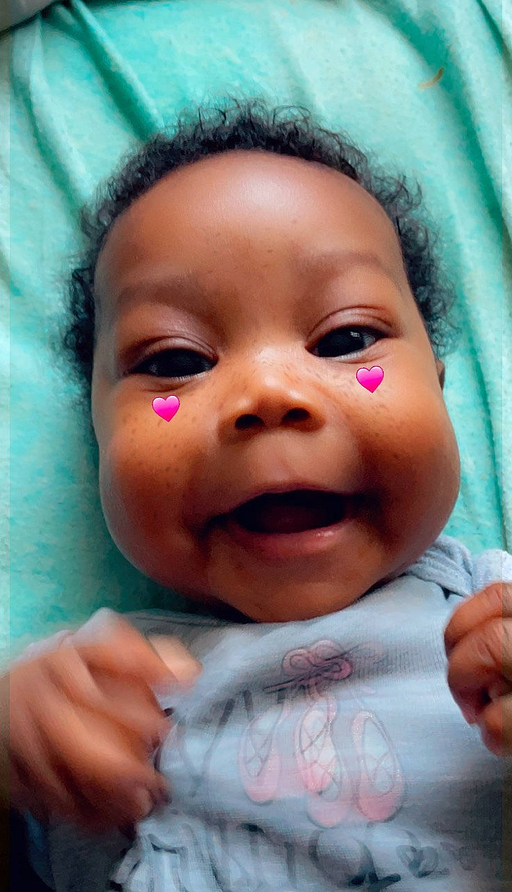 Nyomii is registered to the contest to win money with this photo: azure, baby, cheek, eyebrow, eyelash, finger, forehead, gesture, hand, happy, iris, jaw, lip, mouth, nose, person, pink, skin, smile, thumb