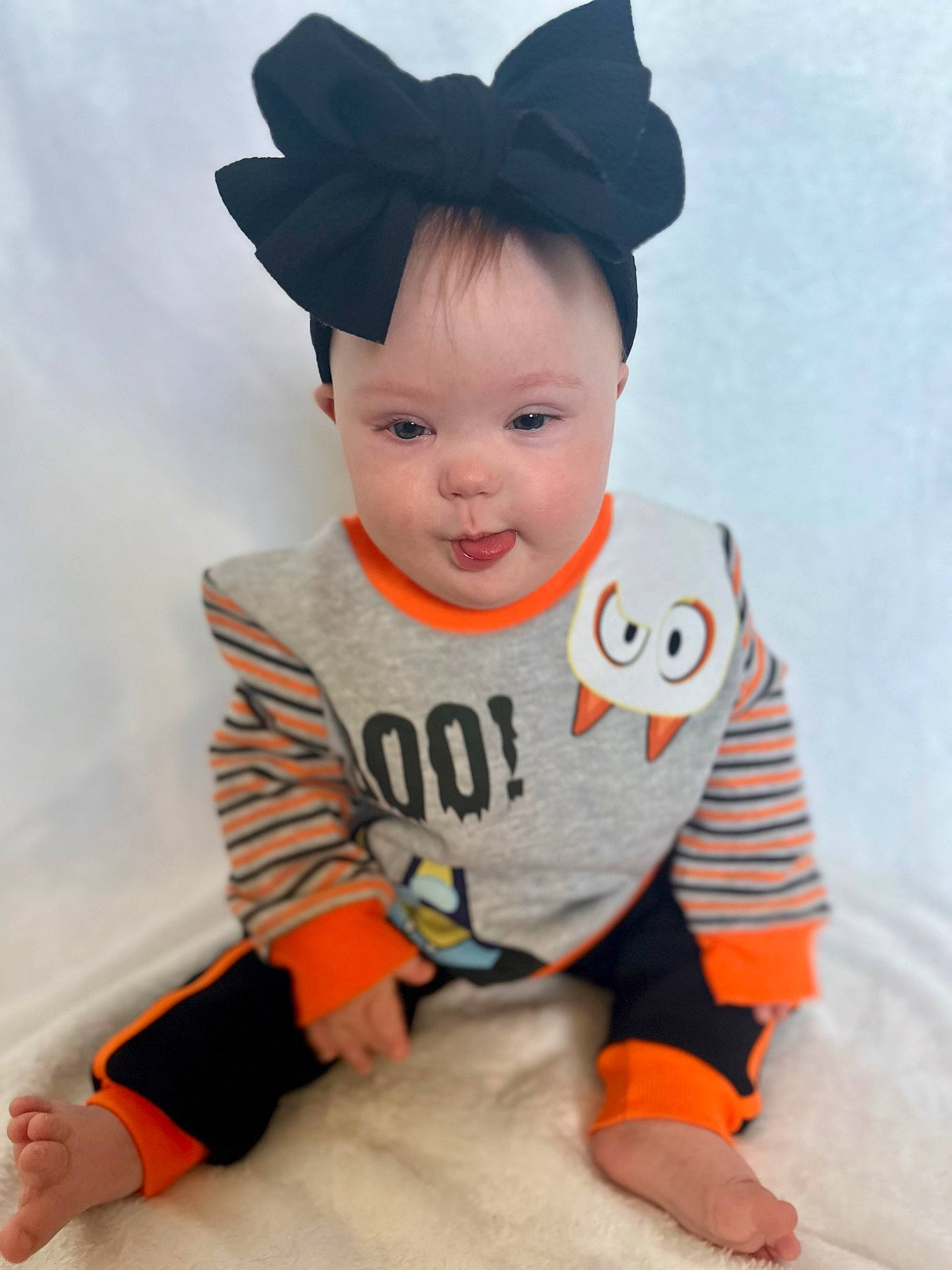 Evangeline is registered to the contest to win money with this photo: baby, baby_toddler_clothing, beanie, cap, child, costume_hat, eye, fashion_accessory, happy, hat, head, headgear, human_body, orange, pattern, person, sleeve, smile, sportswear, t_shirt