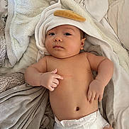 Huckleberry joined the competition — help win amazing prizes! baby, blanket, casual, child, comfort, cozy, cute, diaper, expression, face, hooded_towel, indoors, infant, lying_down, newborn, relaxed, resting, skin, soft, towel