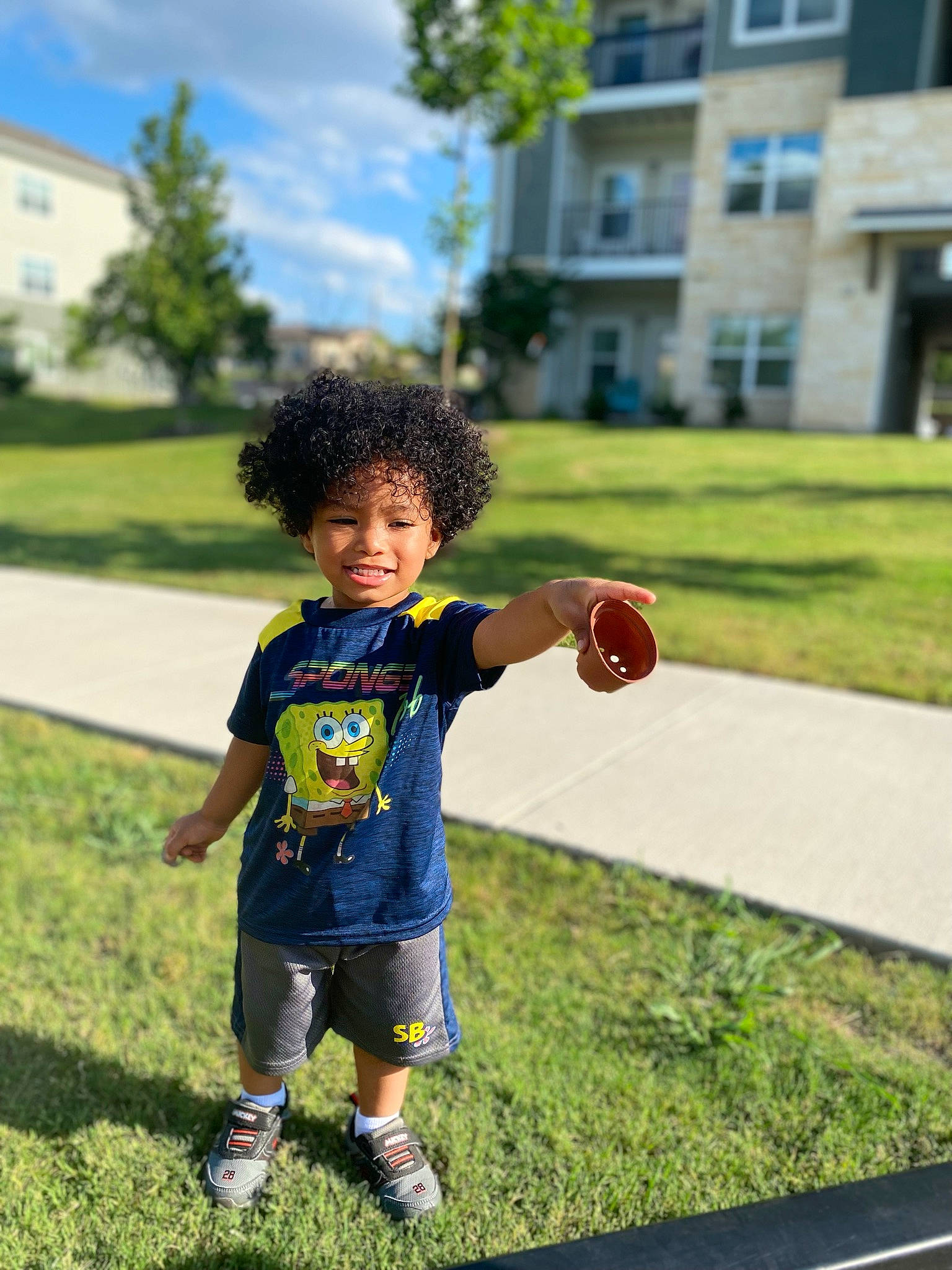 Zayvion joined the competition — help win amazing prizes! asphalt, ball, competition_event, fun, grass, happy, leisure, people_in_nature, person, plant, player, recreation, road, shorts, sky, sneakers, sports_equipment, summer, t_shirt, toddler