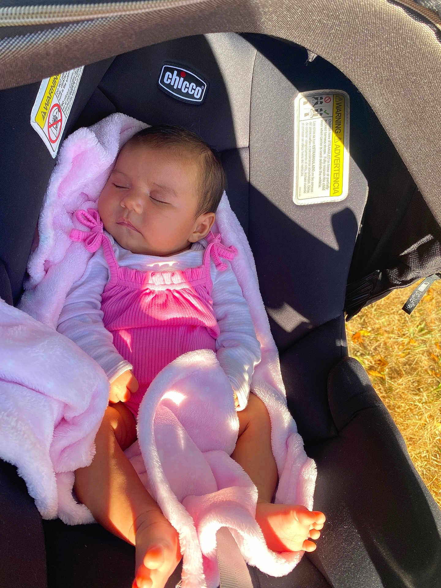 Amelia is registered to the contest to win money with this photo: baby, sleeping, pink_blanket, pink_outfit, car_seat, chicco, infant, child, sunlight, shadow, soft_texture, cozy, resting, cute, newborn, foot, hand, head, portrait, outdoor