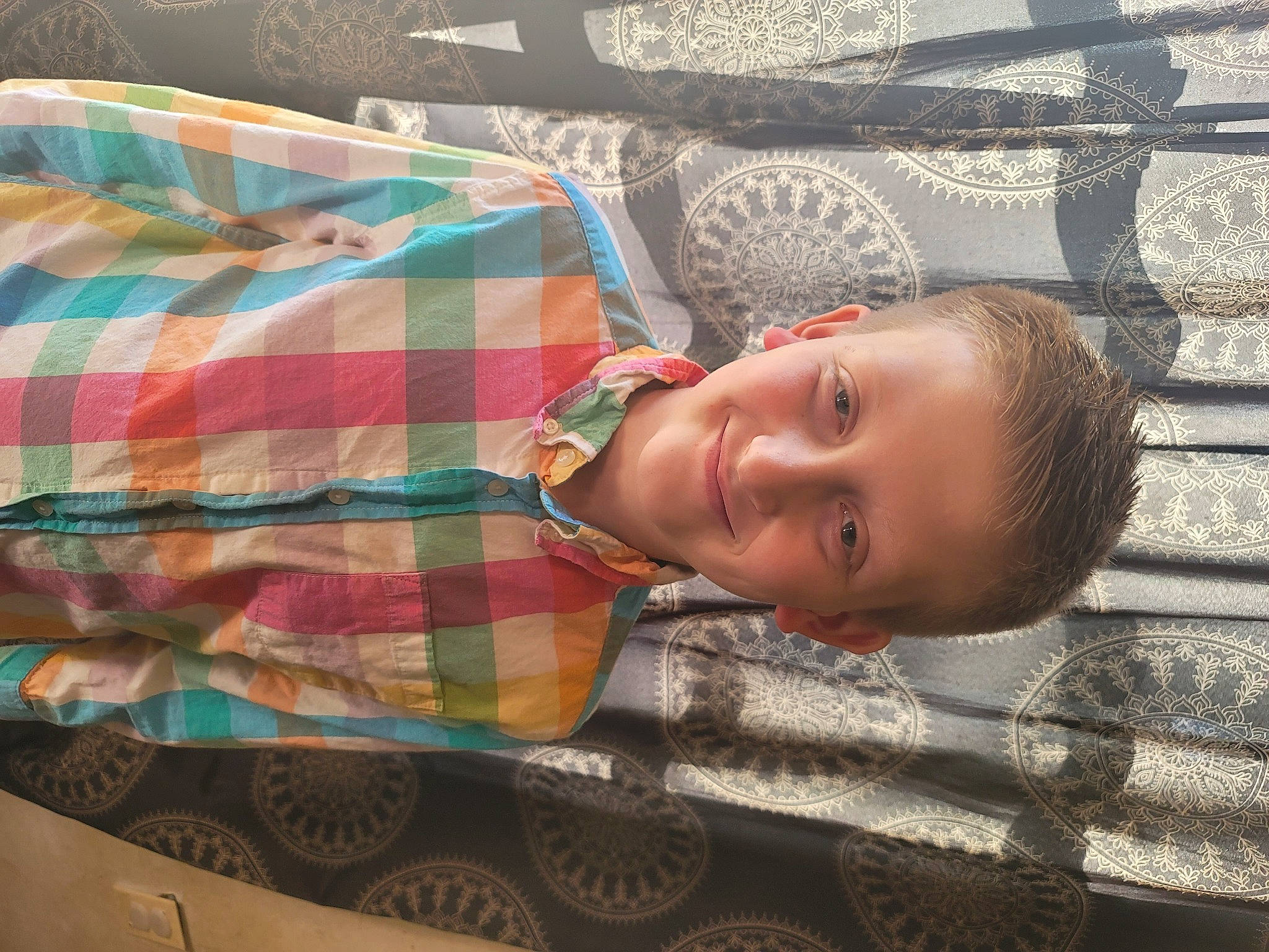 Cameron joined the competition — help win amazing prizes! baby_toddler_clothing, bedding, child, comfort, flooring, fun, grass, happy, joy, linens, pattern, person, plaid, sitting, sleeve, smile, t_shirt, tartan, tints_and_shades, toddler