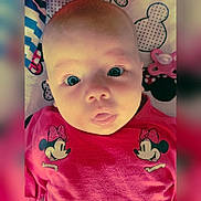 Mya participe au concours pour gagner de l'argent avec cette photo : baby, infant, face, eyes, mouth, pink_shirt, minnie_mouse, pacifier, blanket, cute, child, portrait, closeup, expression, lying_down, skin, head, clothing, pattern, adorable