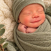 Axle joined the competition — help win amazing prizes! newborn, baby, sleeping, portrait, face, smiling, hat, beanie, swaddled, blanket, basket, cozy, indoor, photography, infant, hands, knitwear, green, peaceful, closeup