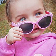 Olivia joined the competition — help win amazing prizes! child, toddler, sunglasses, pink, hoodie, outdoor, grass, face, hand, blue_eyes, casual_clothing, cute, person, portrait, young_child, fashion, fall, nature, expression, fun
