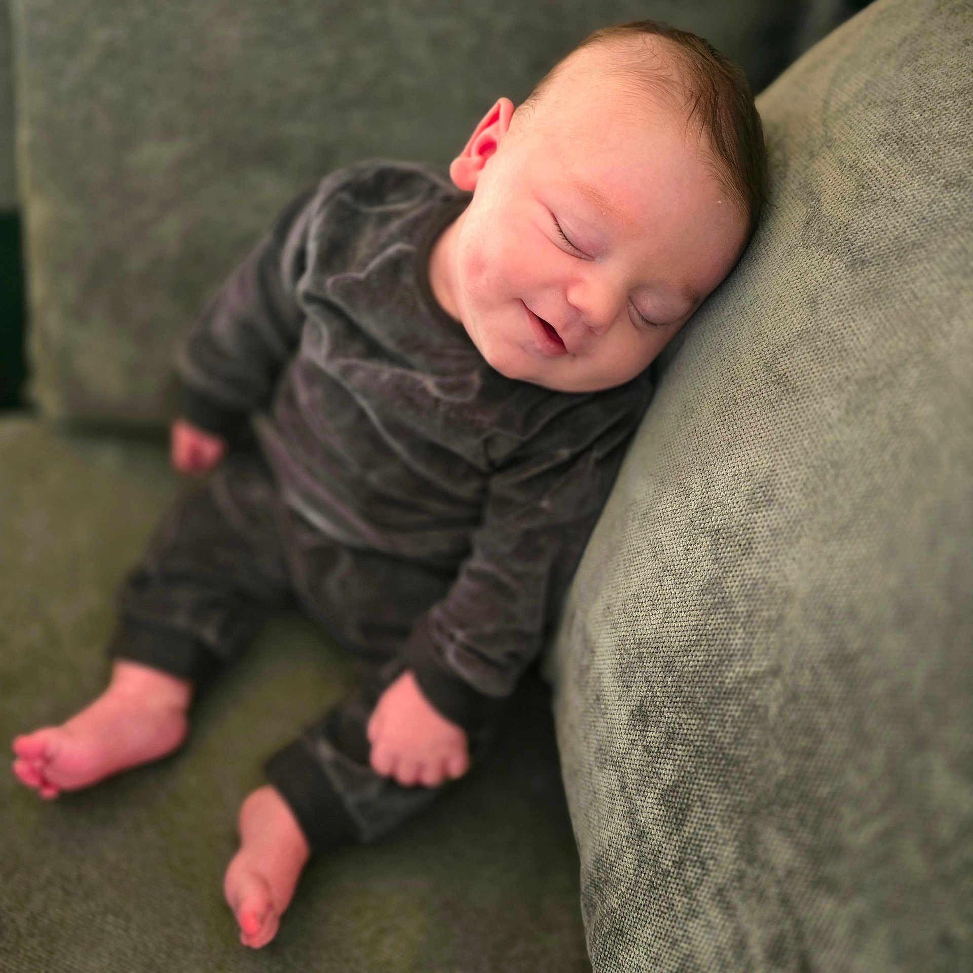 Jenson-Lee is registered to the contest to win money with this photo: baby, child, clothing, comfortable, couch, cozy, cute, furniture, green, home, indoor, infant, peaceful, portrait, relaxation, rest, sleeping, smile, soft, young_child