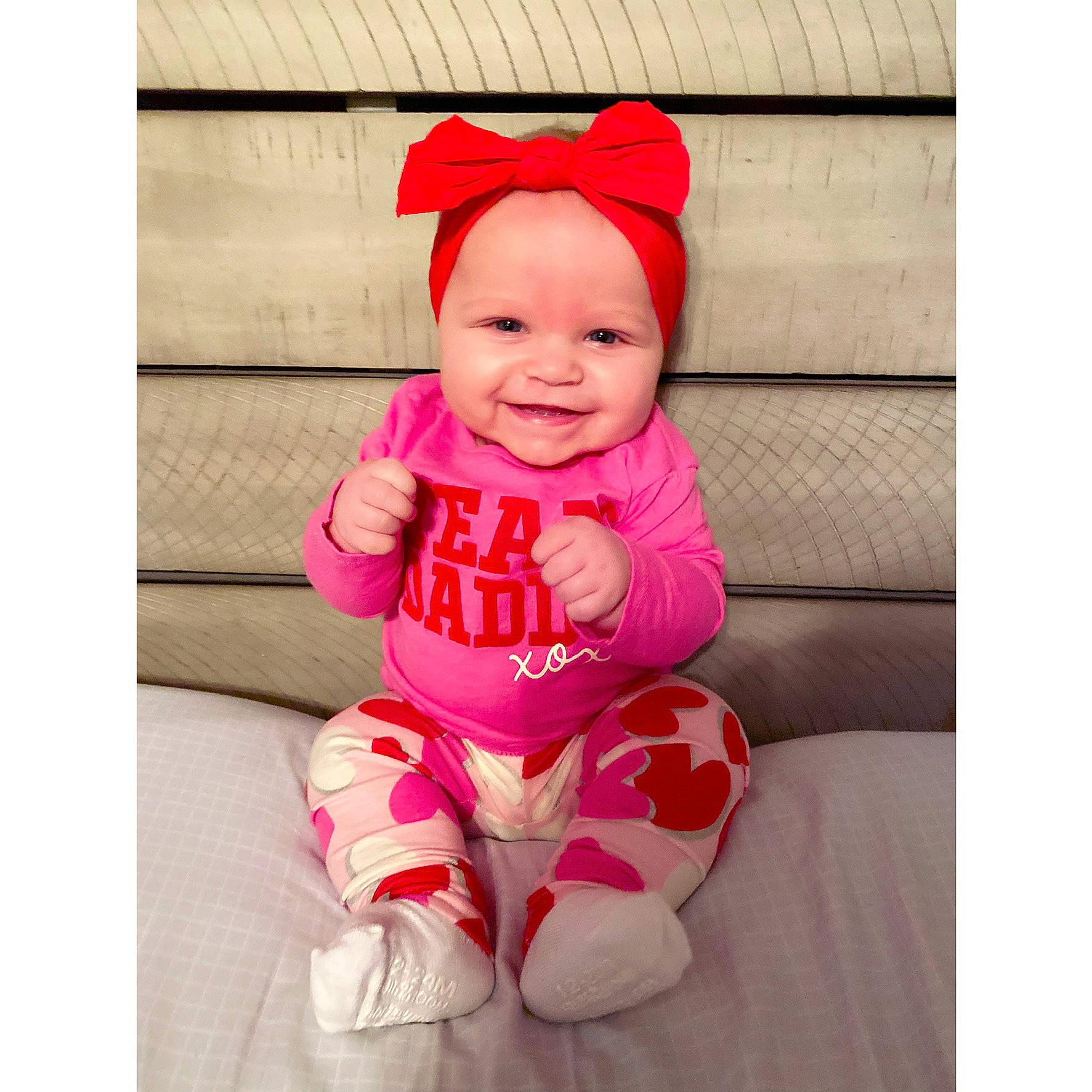 Aubree is registered to the contest to win money with this photo: baby, baby_toddler_clothing, cap, clothing, comfort, face, happy, head, headgear, headwear, human_body, joy, leg, outerwear, person, pink, product, shirt, sleeve, smile