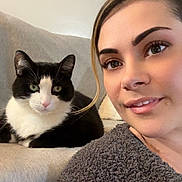 Gigi joined the competition — help win amazing prizes! animal, black_and_white_cat, casual, cat, companion, couch, cozy, eyes, face, fur, furniture, gray_sweater, home, indoor, pet, portrait, relaxing, resting, smile, woman